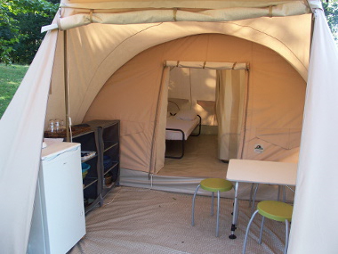 Karsten rental tent with real beds, fridge, cooking and tableware.
