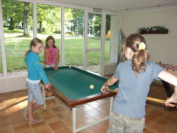 Entertainment space with a pool table, table football and board games.